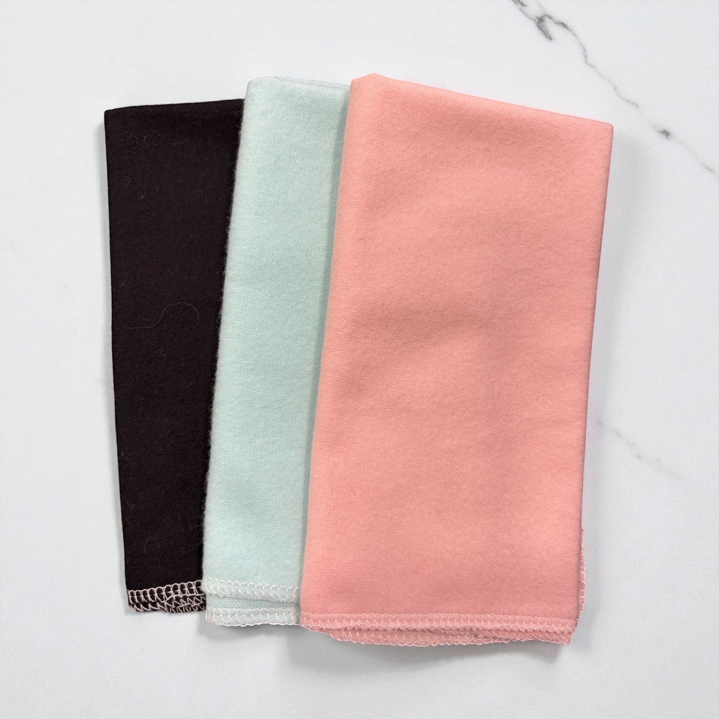 Crafts by Serenity reusable paper towels in black, mint, and peach, featuring durable serged edges.